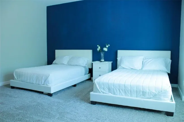 a bedroom with a bed and lamp