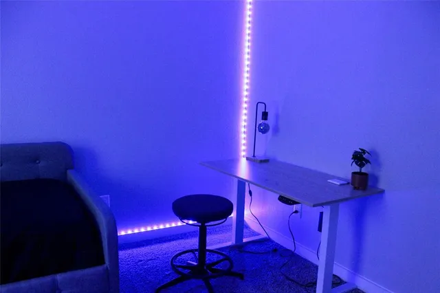 a view of a room with a table and chairs