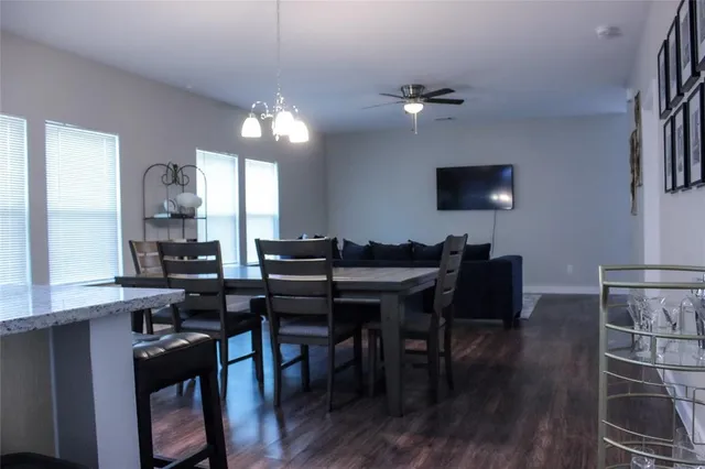 a view of a dining room with furniture and wooden floor