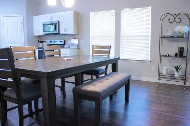 a view of a dining room with furniture and wooden floor