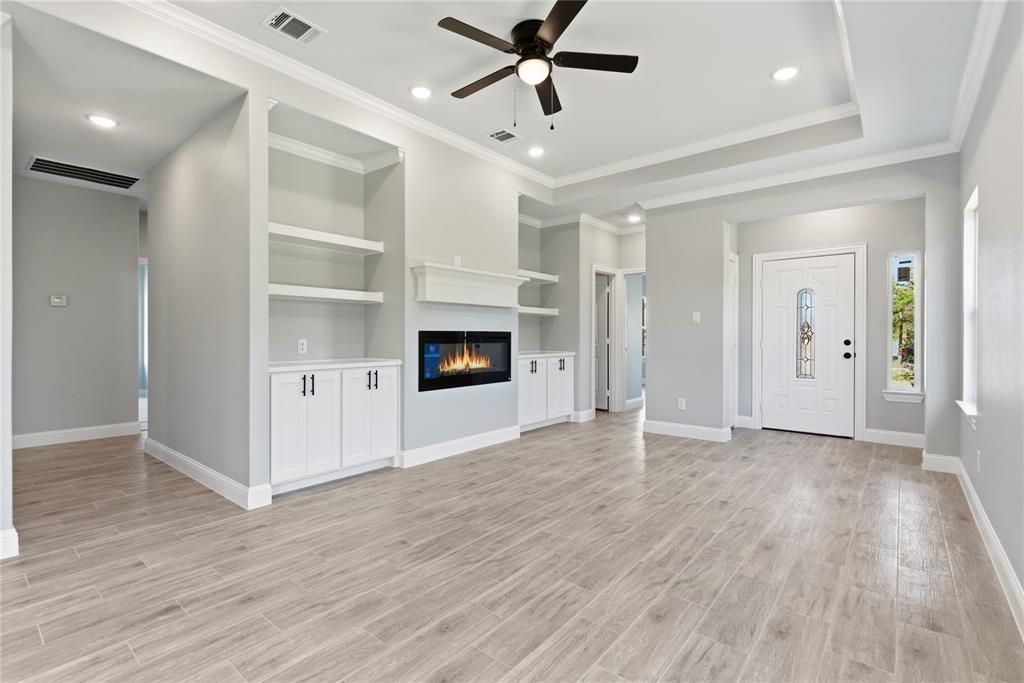 420 Ball Street Tom Bean, TX 75491 - Photo 11 of 34 an empty room with wooden floor fireplace and windows