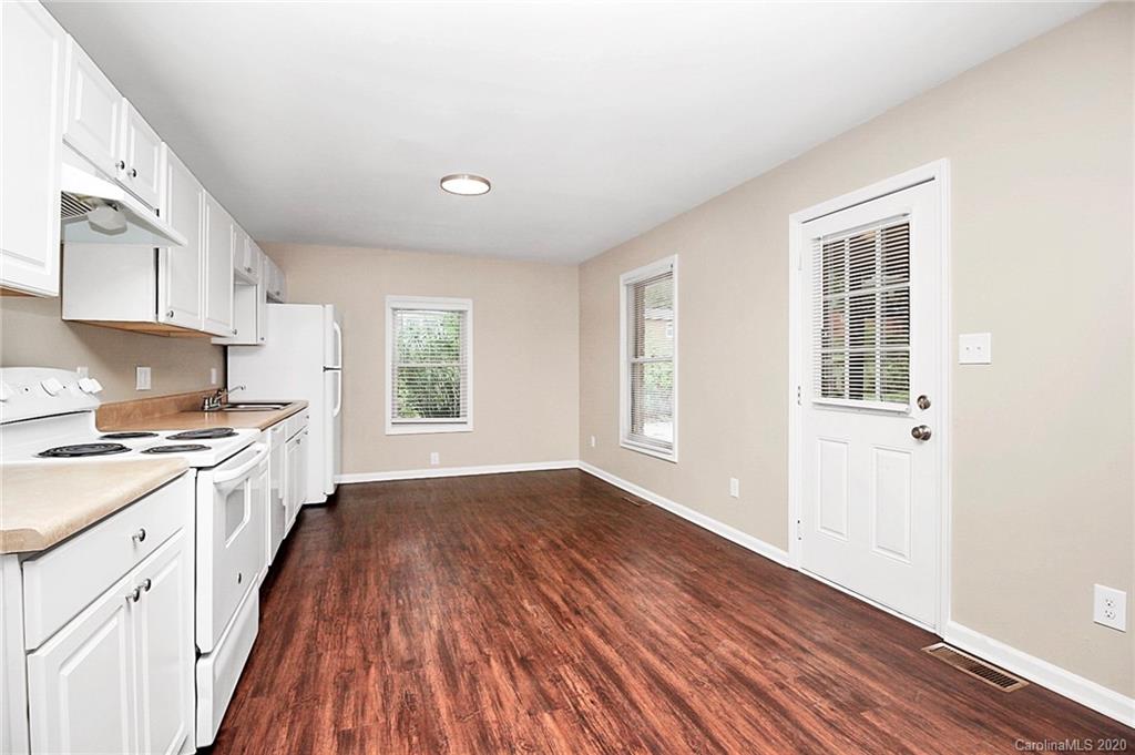 307 Harris Street Fort Mill, SC 29715 - Photo 11 of 39 a large kitchen with cabinets wooden floor and stainless steel appliances