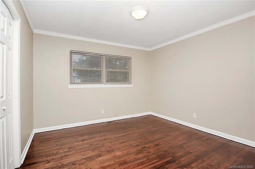 307 Harris Street Fort Mill, SC 29715 - Photo 16 of 39 an empty room with wooden floor and windows