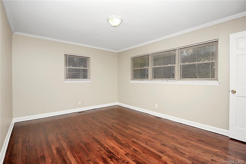 307 Harris Street Fort Mill, SC 29715 - Photo 19 of 39 an empty room with wooden floor and windows