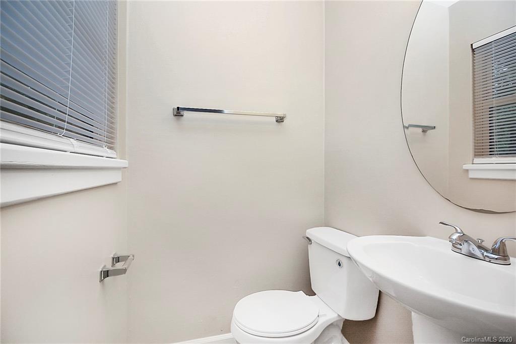 307 Harris Street Fort Mill, SC 29715 - Photo 22 of 39 a white toilet sitting next to a bathroom sink