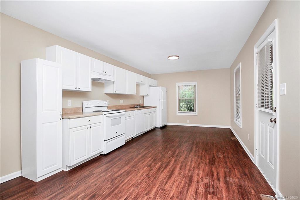 307 Harris Street Fort Mill, SC 29715 - Photo 9 of 39 a kitchen with wooden floors and white appliances
