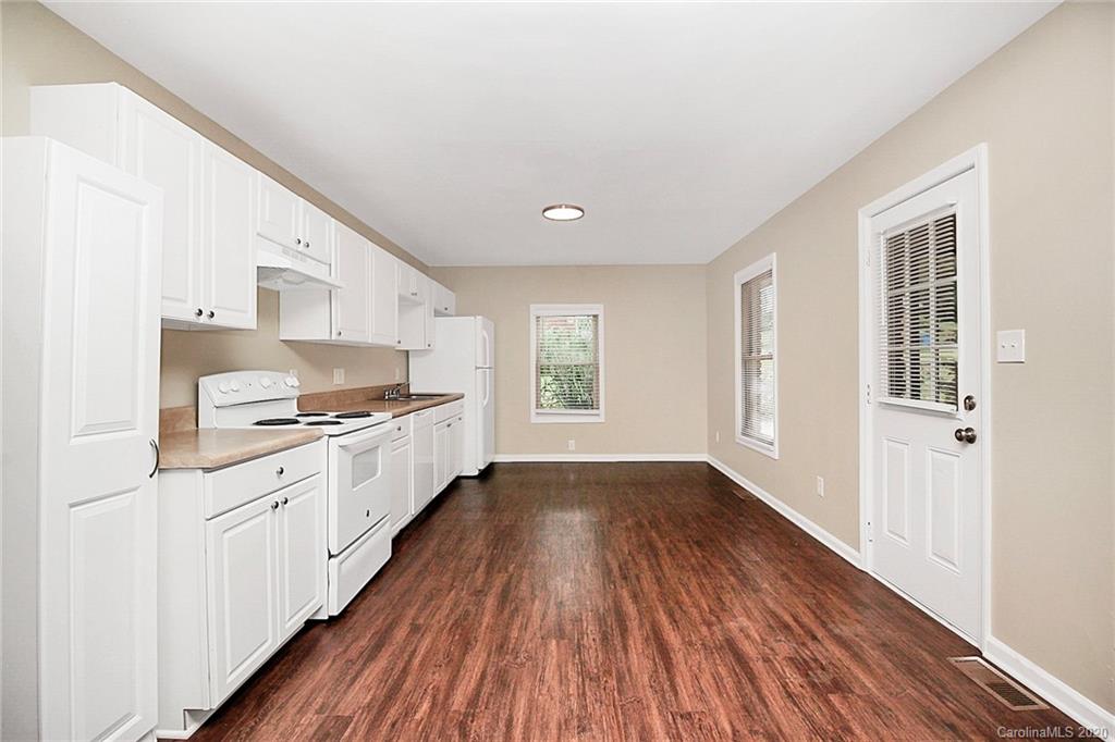 307 Harris Street Fort Mill, SC 29715 - Photo 10 of 39 a large kitchen with a white stove top oven and white cabinets