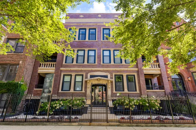 a front view of a residential apartment building with a yard