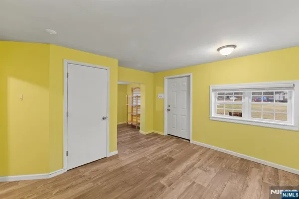 a view of a room with wooden floor and windows