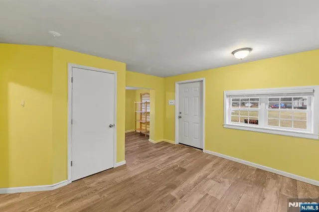 a view of a room with wooden floor and windows