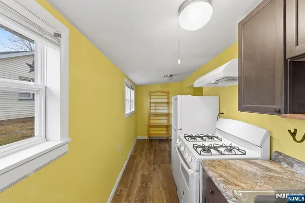 a kitchen with a stove and a refrigerator