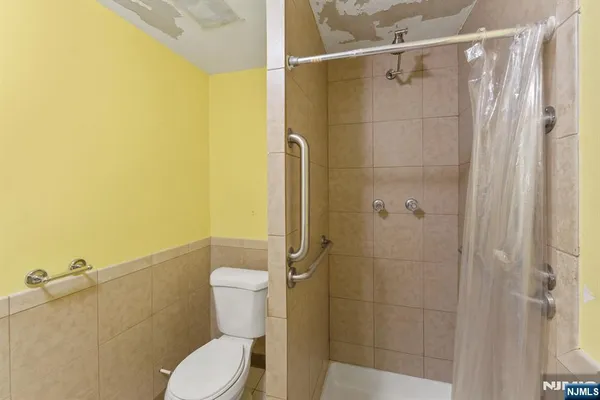 a white toilet sitting next to a bathroom sink