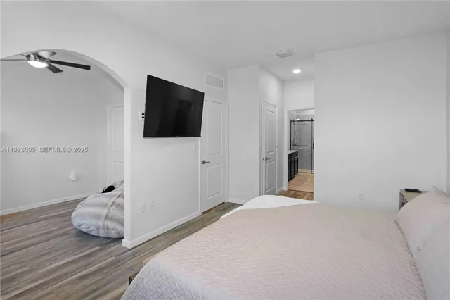 a bedroom with a bed and a flat screen tv