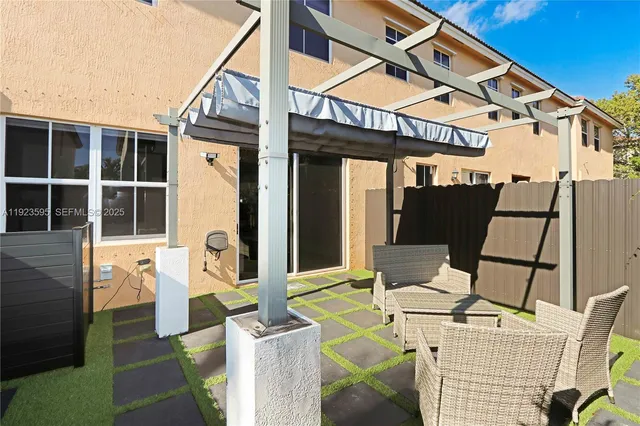 a view of a patio with table and chairs