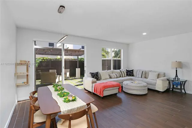 a bedroom with bed and large windows