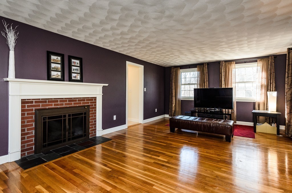 8 Circle Road Lexington, MA 02420 - Photo 5 of 10 a living room with furniture a flat screen tv and a fireplace