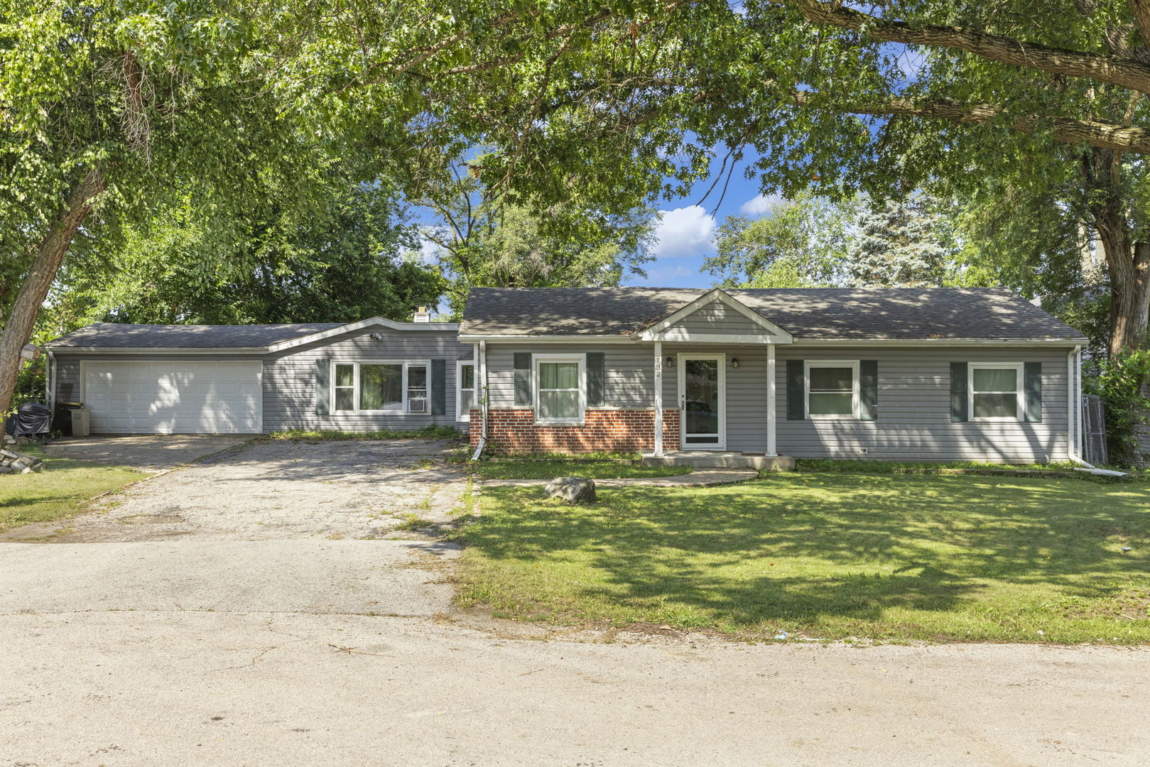 S732 Myrtle Street Winfield, IL 60190 - Photo 1 of 10 a front view of a house with a garden and trees