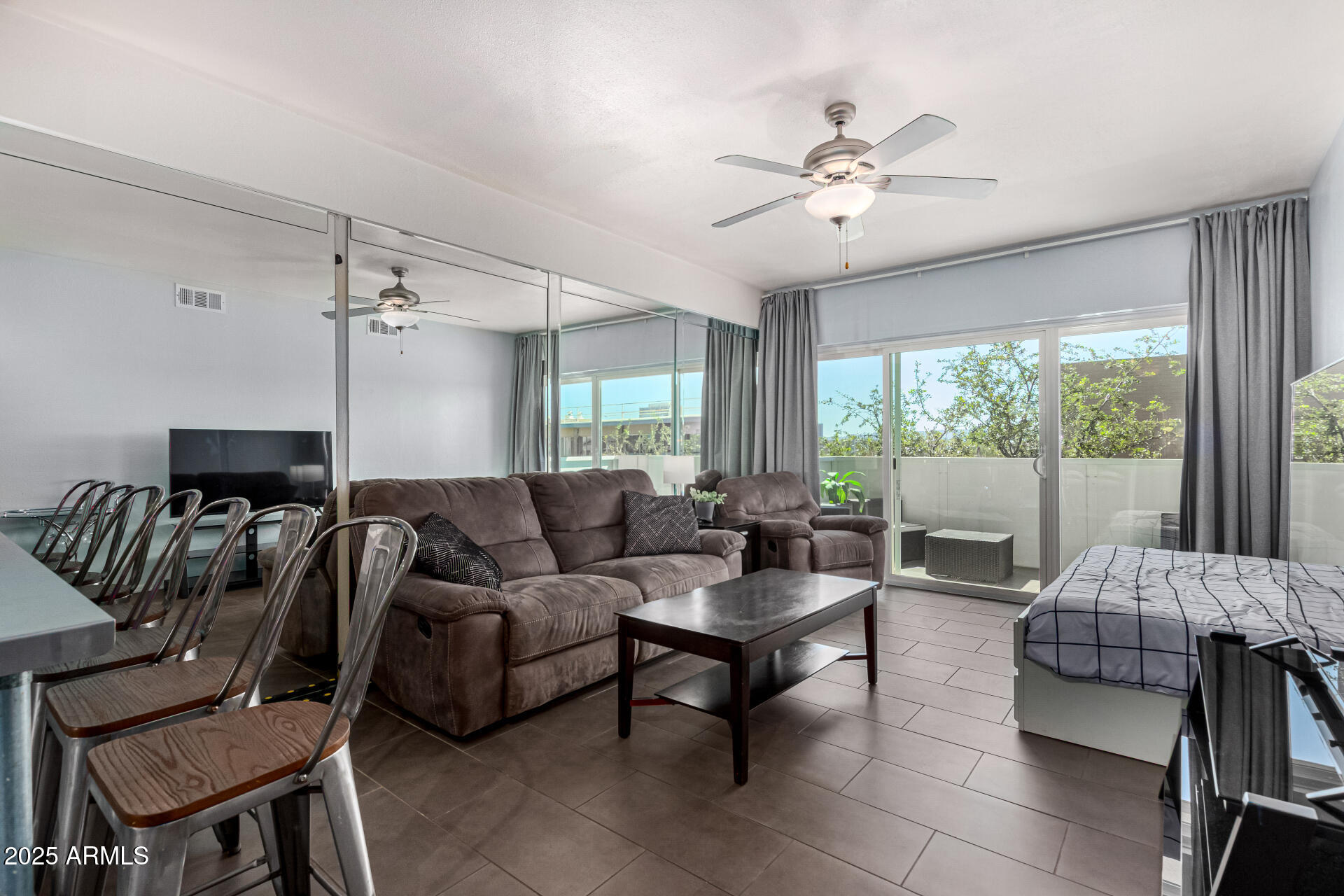 351 East Thomas Road, Unit D505 Phoenix, AZ 85012 - Photo 9 of 28 a living room with furniture and a large window