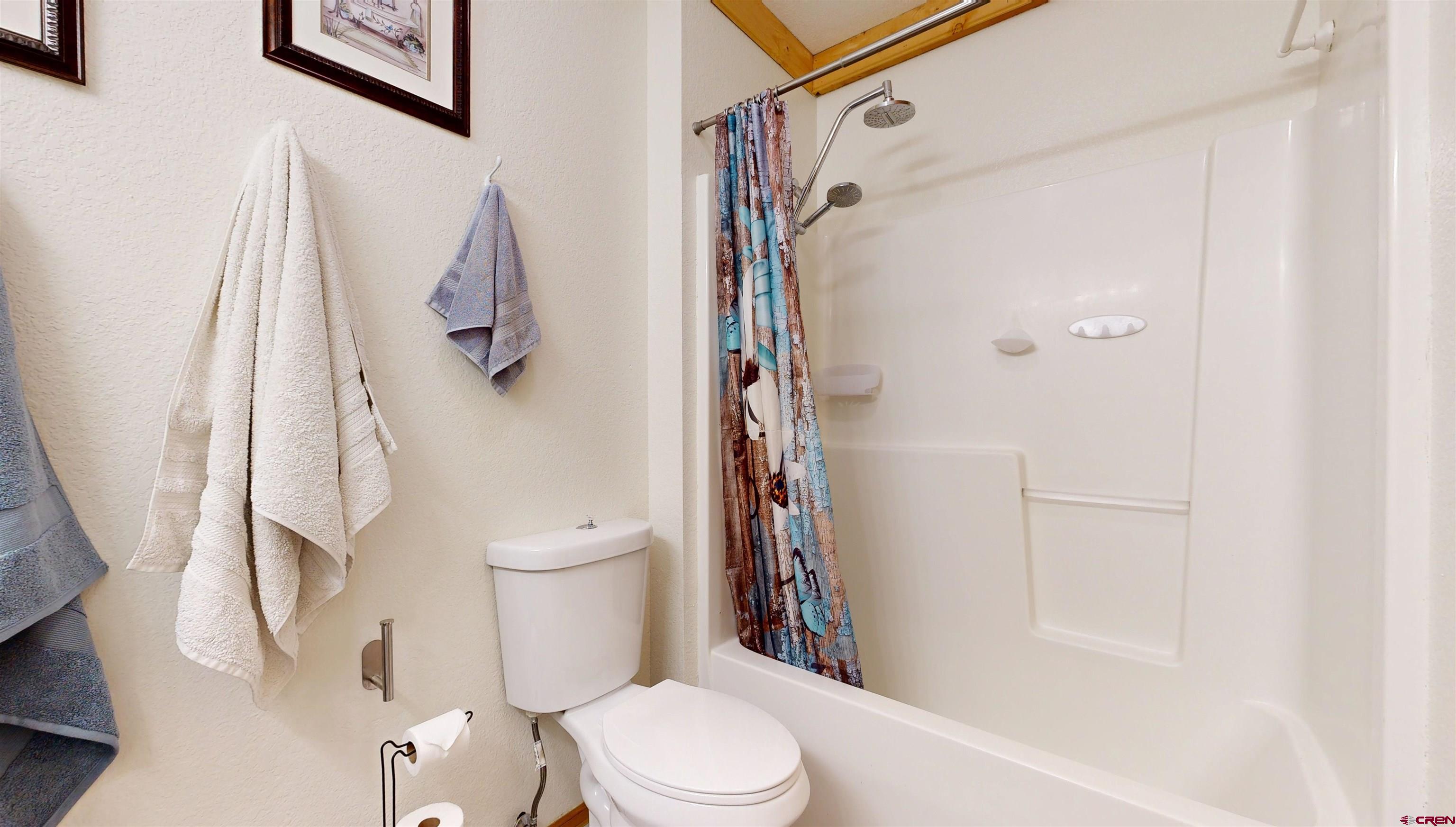 2083 Pioneer Road Delta, CO 81416 - Photo 19 of 45 a white toilet sitting next to a bath tub