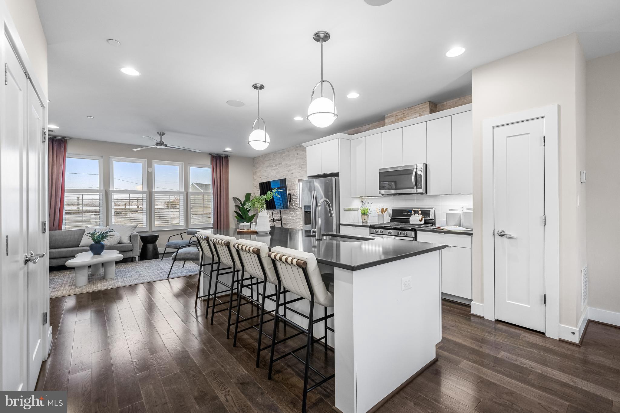 1600 Beason Street Baltimore, MD 21230 - Photo 15 of 53 a view of a kitchen with kitchen island a large counter space a sink stainless steel appliances and cabinets