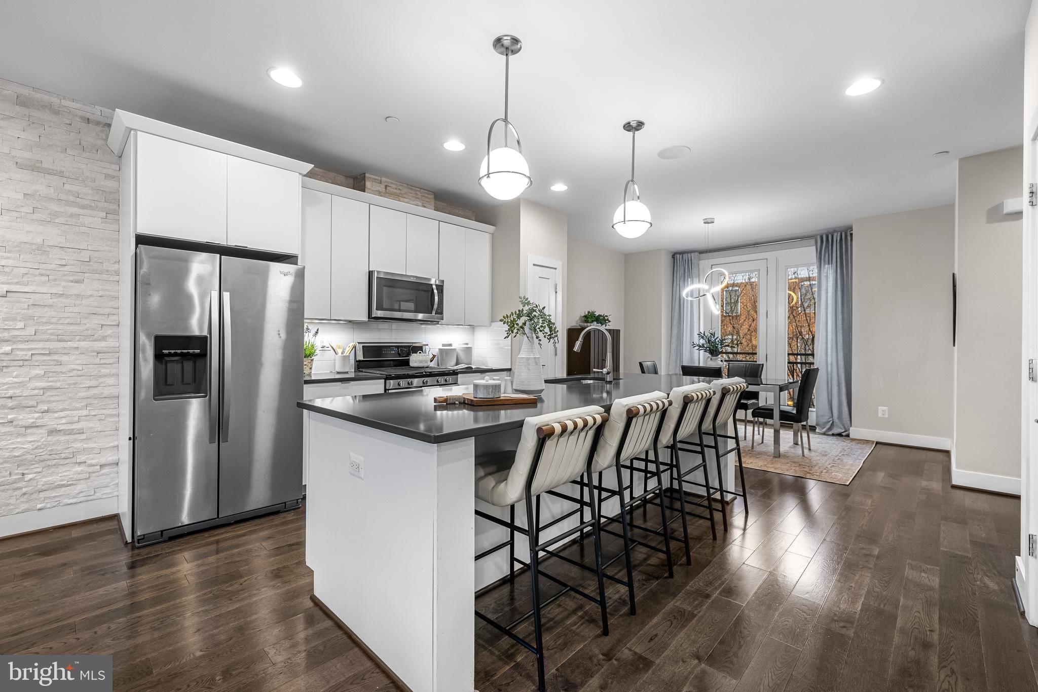 1600 Beason Street Baltimore, MD 21230 - Photo 18 of 53 a kitchen with stainless steel appliances a dining table chairs stove and refrigerator