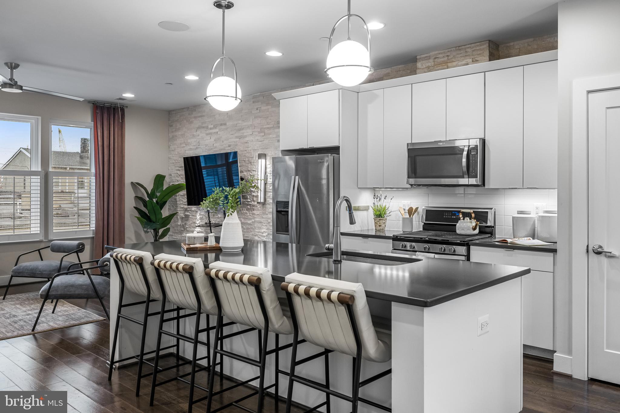 1600 Beason Street Baltimore, MD 21230 - Photo 19 of 53 a kitchen with stainless steel appliances granite countertop a stove top oven a refrigerator a sink and a center island