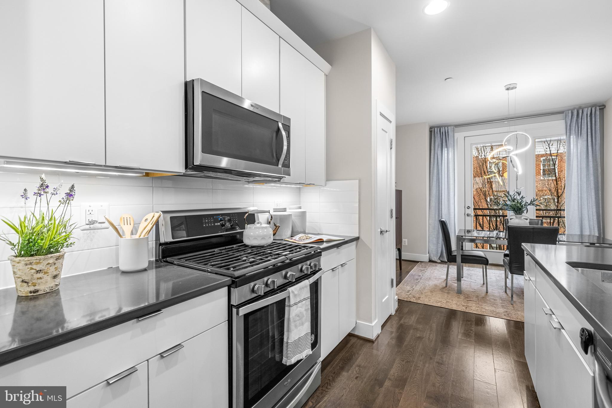 1600 Beason Street Baltimore, MD 21230 - Photo 21 of 53 a kitchen with stainless steel appliances a stove microwave and cabinets