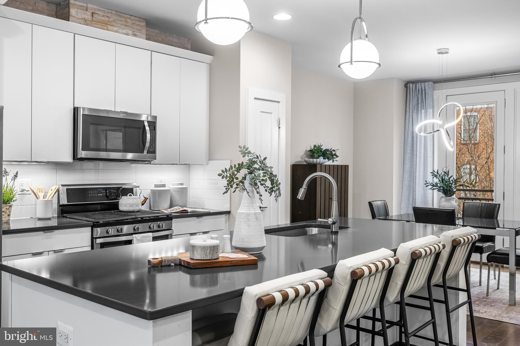 1600 Beason Street Baltimore, MD 21230 - Photo 22 of 53 a kitchen with stainless steel appliances granite countertop a sink a stove and a microwave