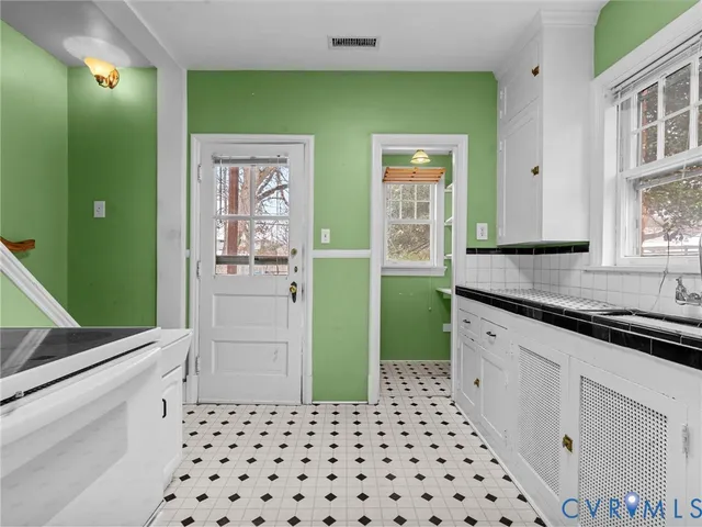 a kitchen with a refrigerator and a sink