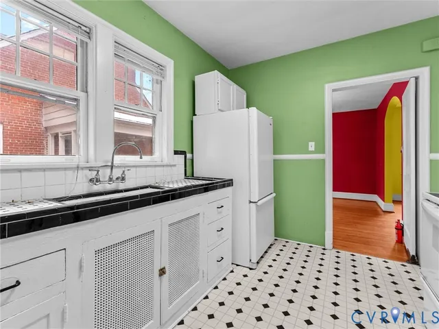 a kitchen with granite countertop a sink and cabinets