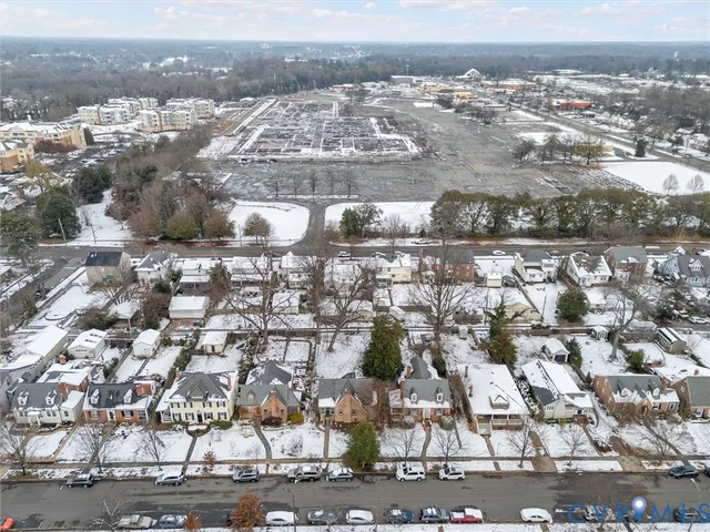 an aerial view of a house with a yard and parking