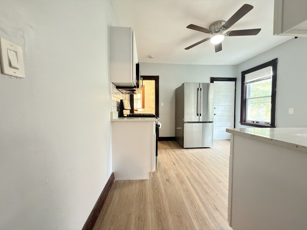 18 Harold Park, Unit 3 Boston, MA 02119 - Photo 32 of 41 a view of a kitchen with a sink and a refrigerator