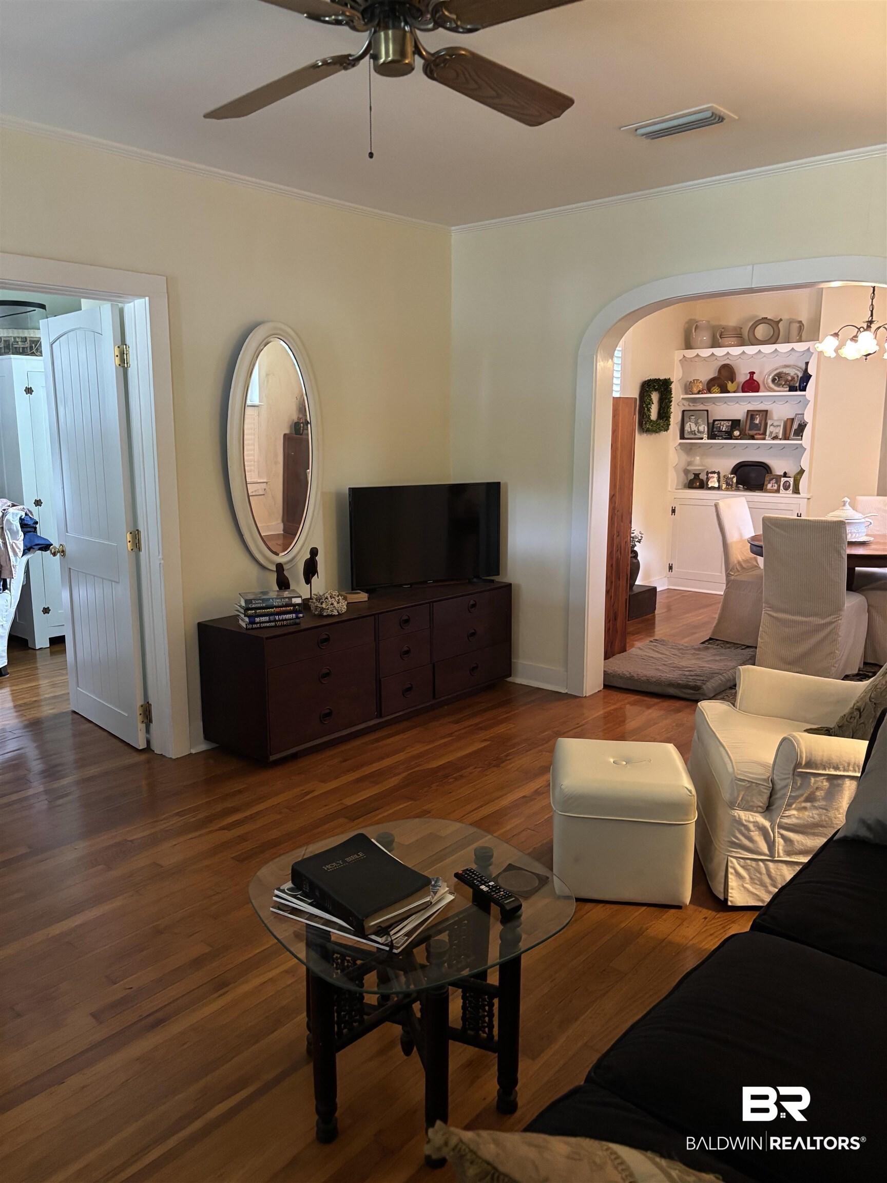 216 West Orange Avenue Foley, AL 36535 - Photo 33 of 37 Living area featuring a ceiling fan, arched walkways, wood finished floors, and ornamental molding