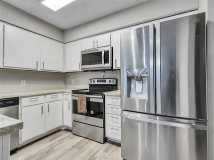 a kitchen with a sink stove and cabinets