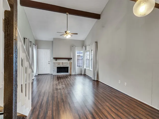 wooden floor in an empty room with a fireplace