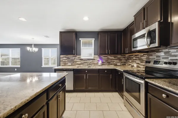 a kitchen with stainless steel appliances granite countertop a sink stove and oven