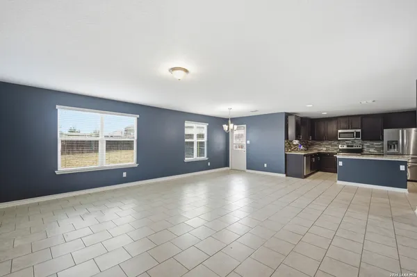 a large open kitchen with a sink and cabinets