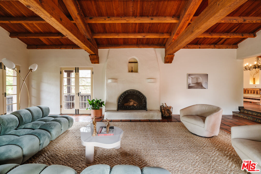 3131 Floye Drive Los Angeles, CA 90046 - Photo 11 of 53 a living room with furniture a fireplace and a large window