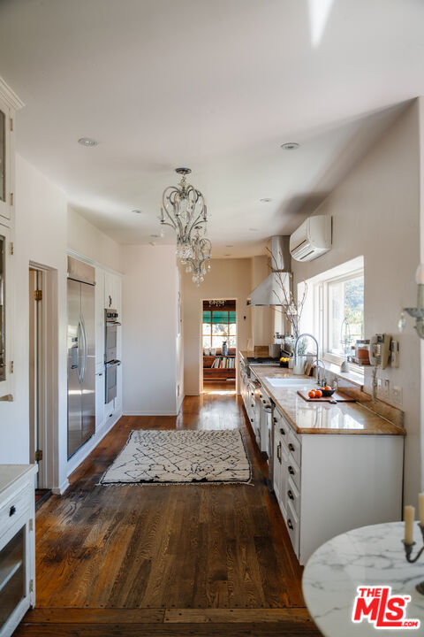 3131 Floye Drive Los Angeles, CA 90046 - Photo 14 of 53 a kitchen with stainless steel appliances granite countertop a sink stove and refrigerator