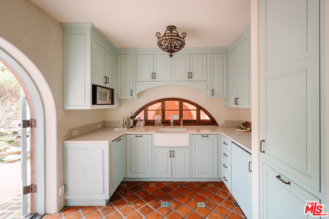 3131 Floye Drive Los Angeles, CA 90046 - Photo 21 of 53 a kitchen with stainless steel appliances granite countertop a stove a sink and a microwave