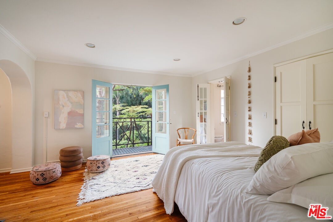 3131 Floye Drive Los Angeles, CA 90046 - Photo 22 of 53 a bedroom with a bed and glass window