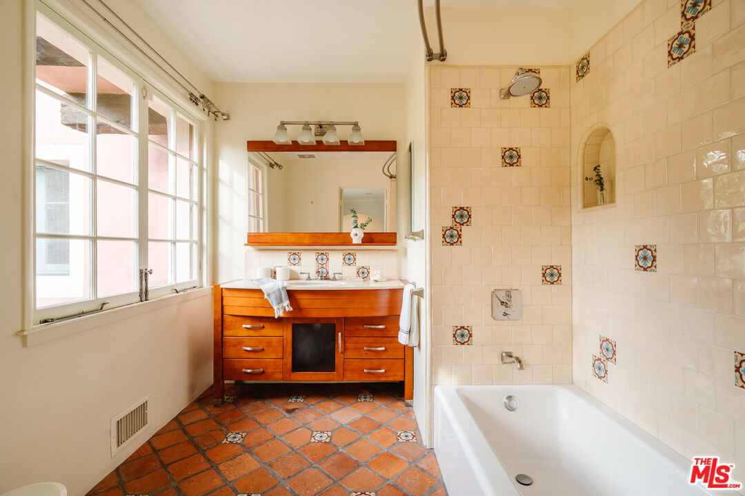 3131 Floye Drive Los Angeles, CA 90046 - Photo 24 of 53 a bathroom with a tub sink and mirror