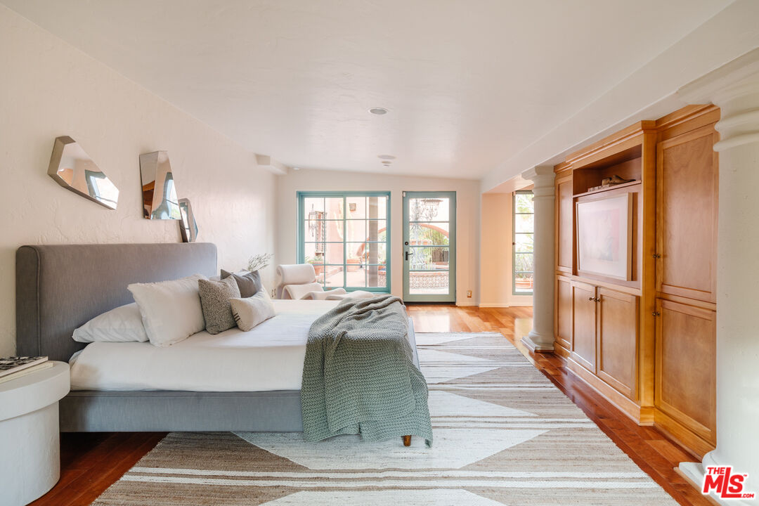 3131 Floye Drive Los Angeles, CA 90046 - Photo 27 of 53 a spacious bedroom with a bed and a large window