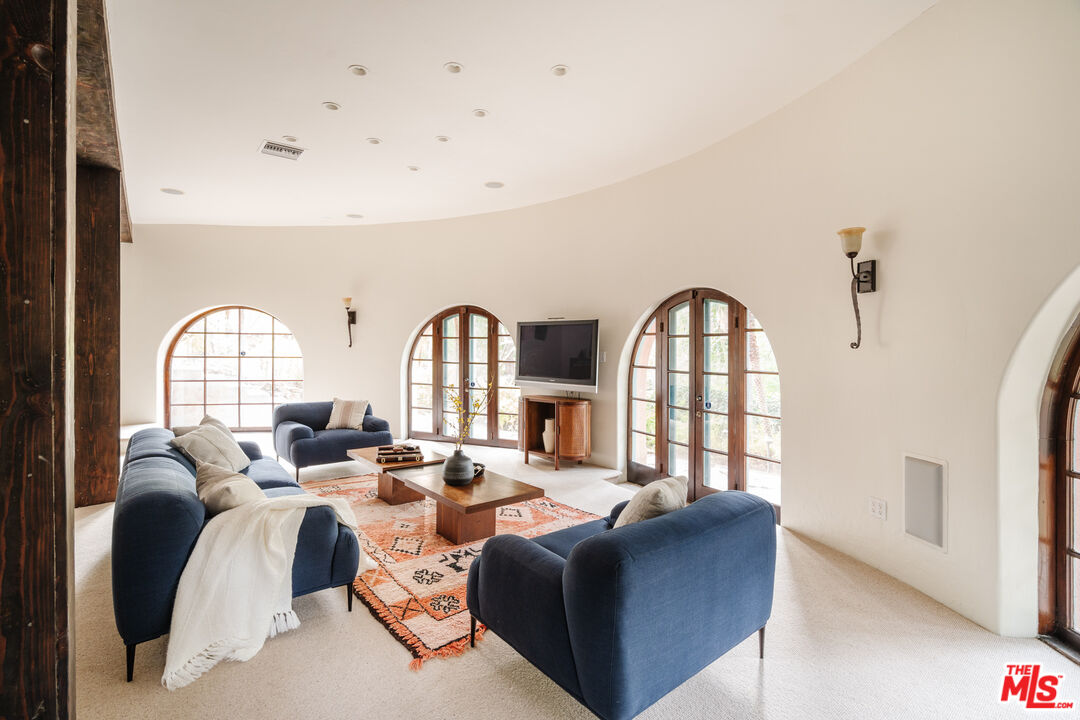3131 Floye Drive Los Angeles, CA 90046 - Photo 30 of 53 a living room with furniture a fireplace and a large window