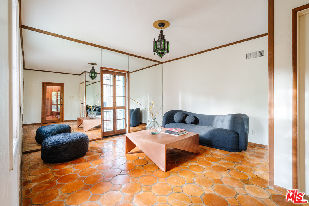 3131 Floye Drive Los Angeles, CA 90046 - Photo 31 of 53 a living room with furniture a rug and a chandelier
