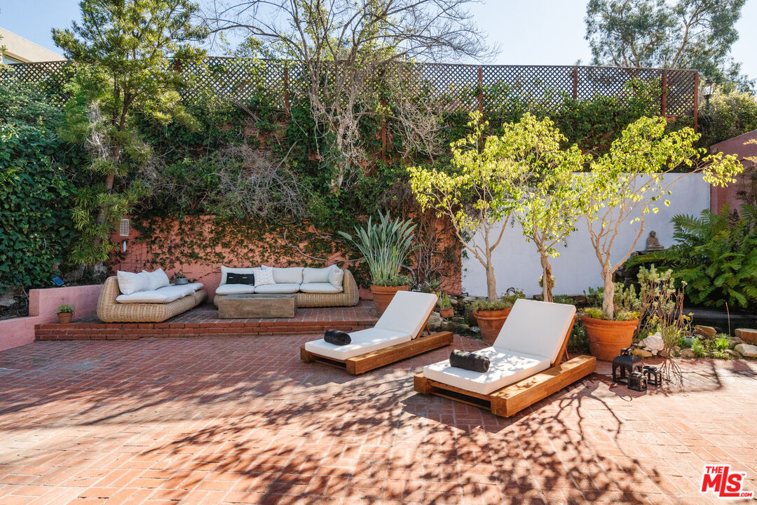 3131 Floye Drive Los Angeles, CA 90046 - Photo 33 of 53 a backyard of a house with table and chairs