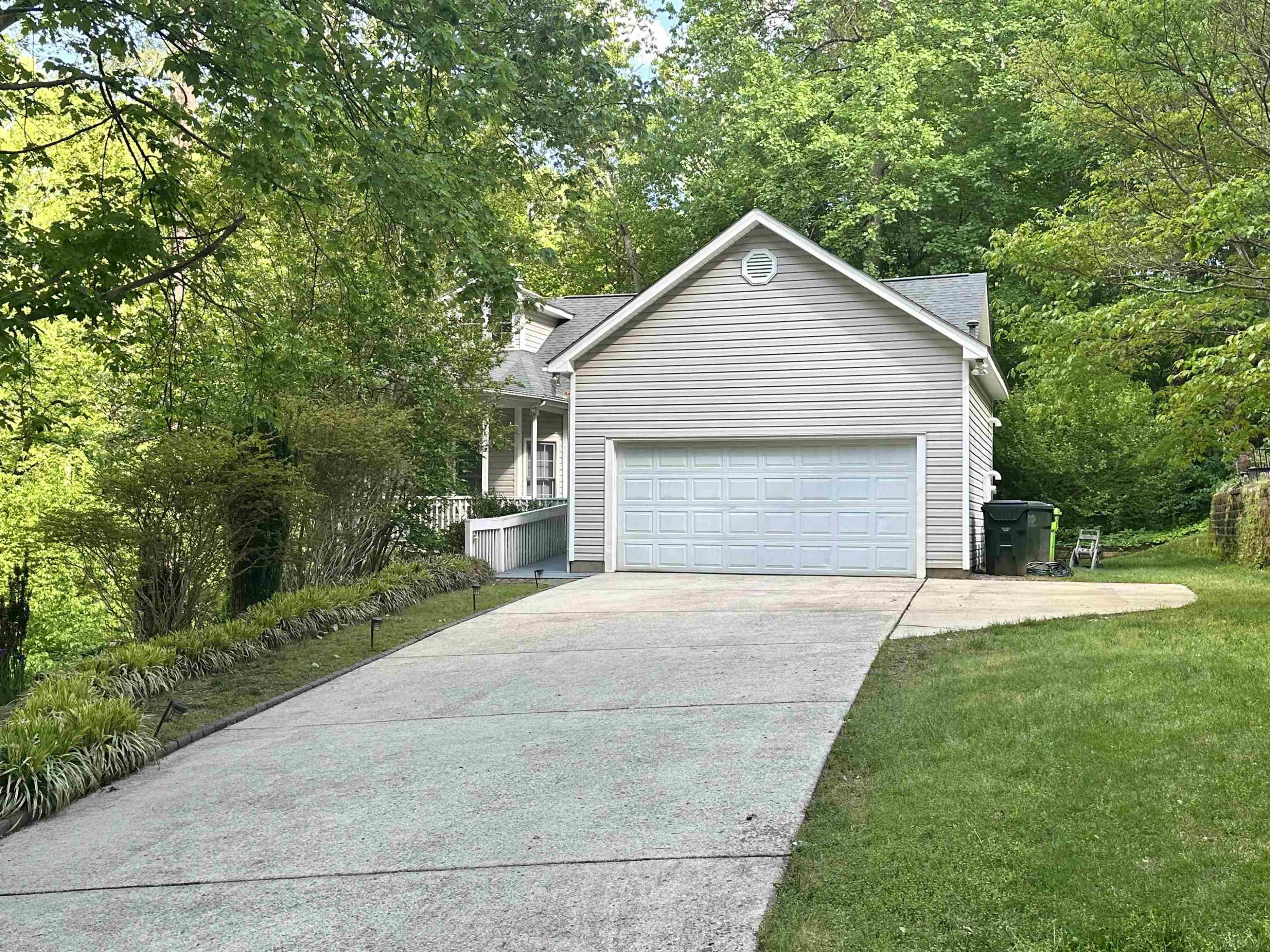 a front view of house with yard and trees
