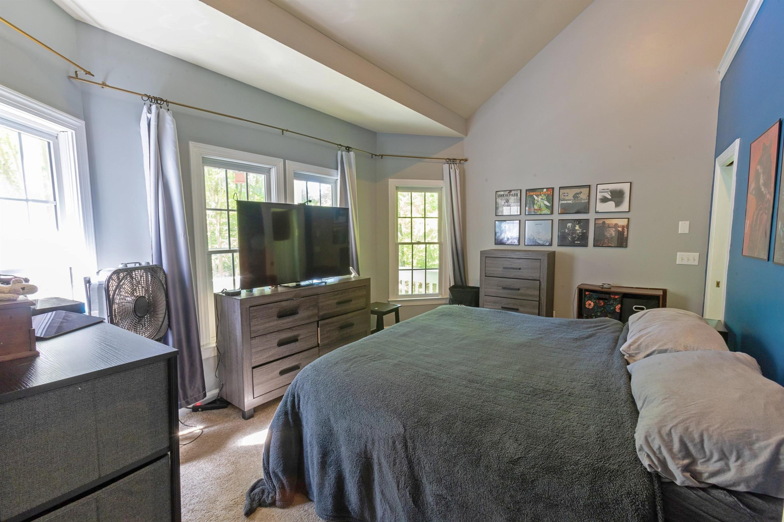 3801 Woodowl Drive Raleigh, NC 27613 - Photo 7 of 13 a bedroom with a bed and a flat screen tv