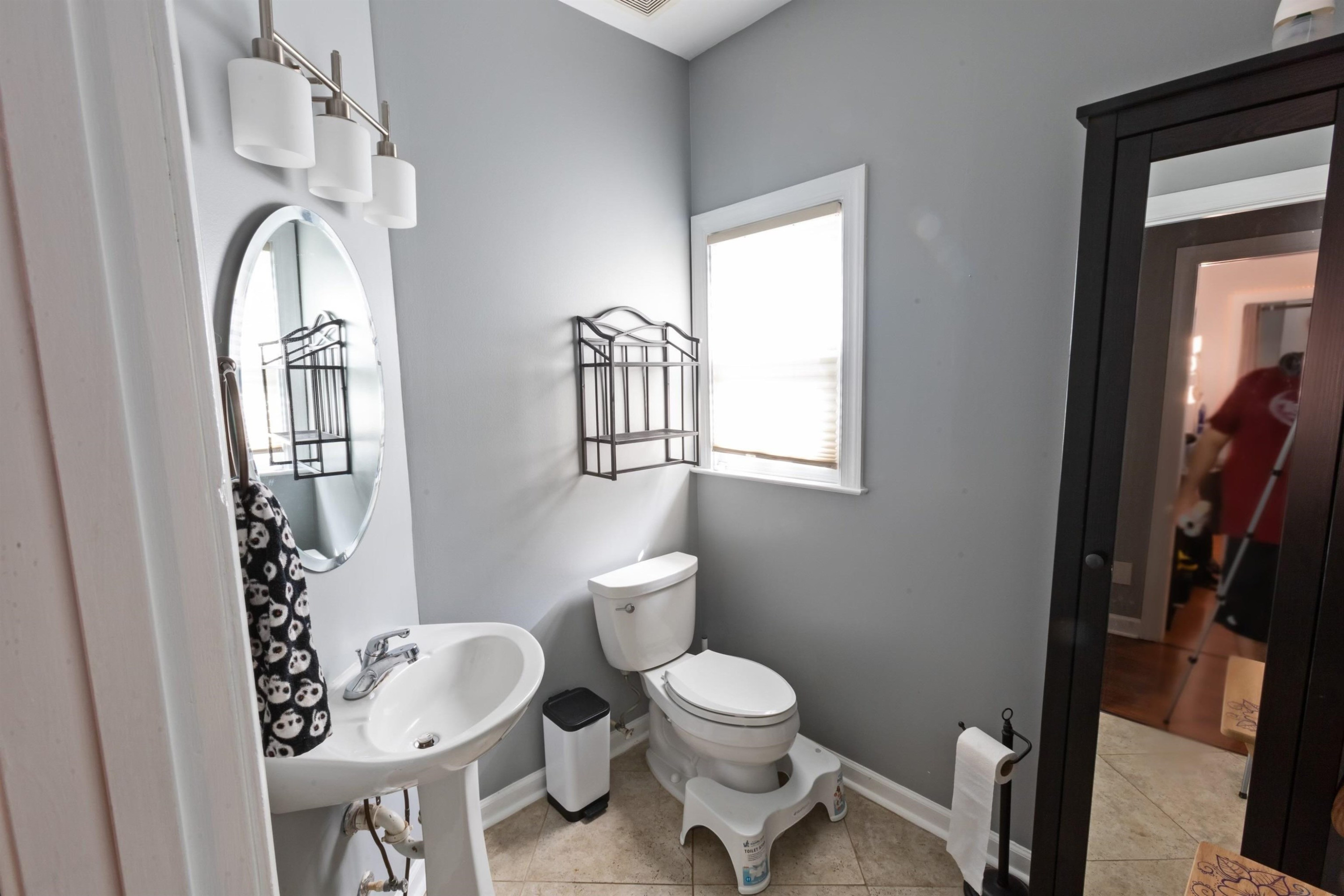 3801 Woodowl Drive Raleigh, NC 27613 - Photo 8 of 13 a bathroom with a toilet a sink and a mirror