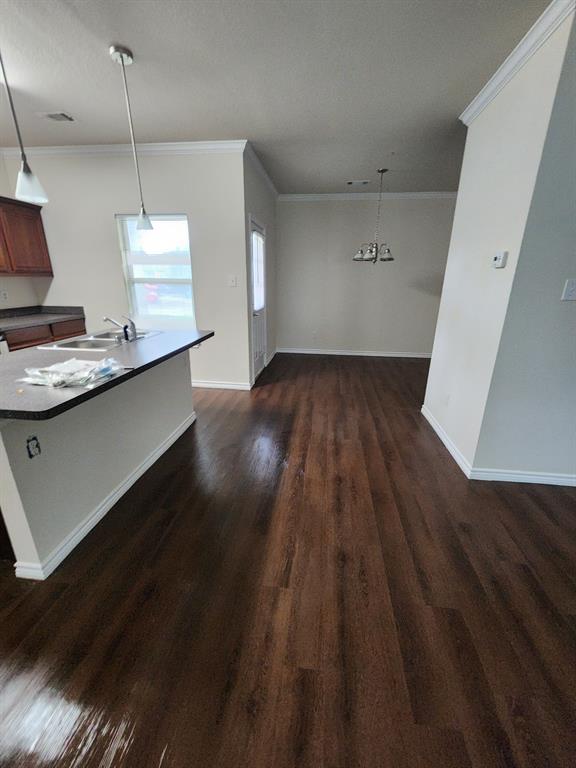 5516 Del Rey Drive Denton, TX 76208 - Photo 5 of 16 a view of a room with wooden floor and white walls